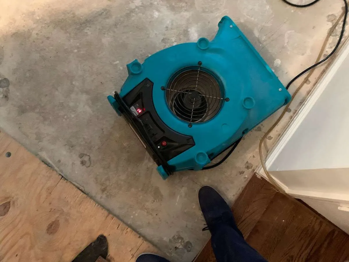Air mover drying subfloor during Commercial Water Damage Restoration in Fargo